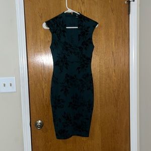 Green with black detail body con dress. Lightly worn in great condition.